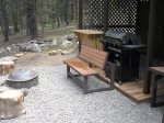 Outside the front door is the barbecue area with grill, fire pit, and bar. Partially covered.